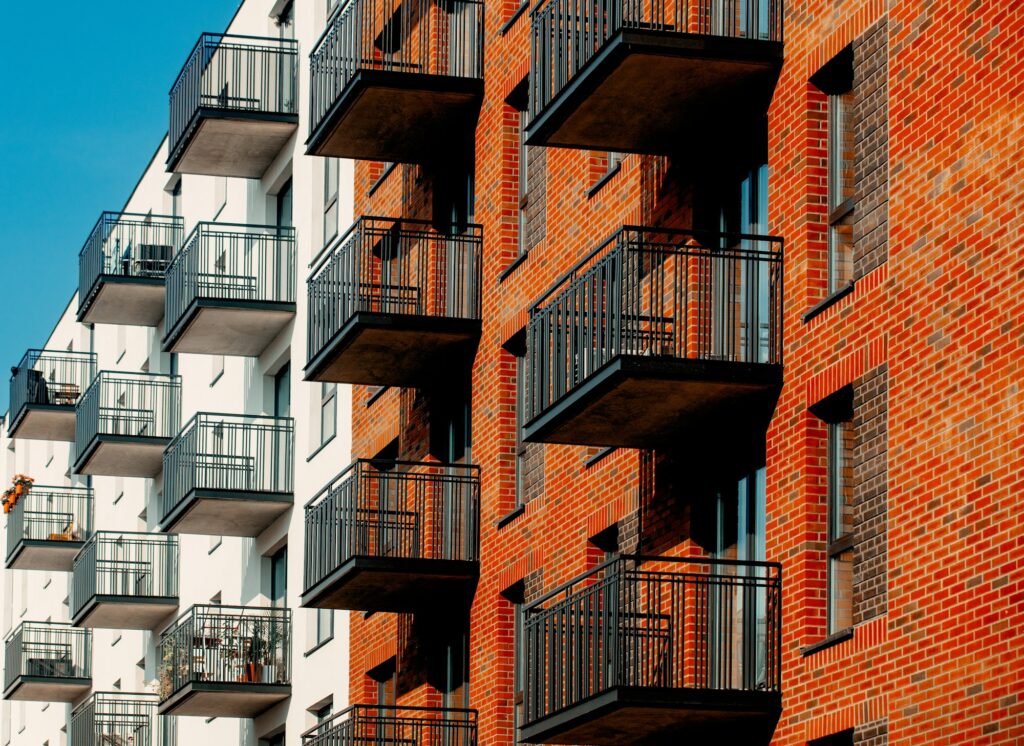 view of a modern brick apartments with balconies